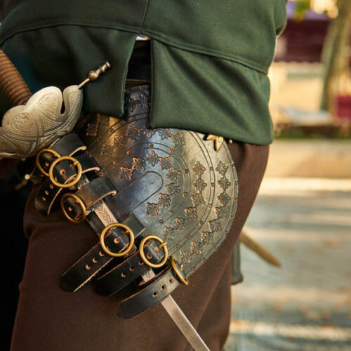 Old soldier sword on a medieval knight costume. Historical reenactment of a weapon.